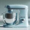 Light blue 2D flat rotating acrylic stand mixer with speed control knob